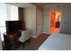 Bedroom features a work desk, chair, and entry to a bathroom at 145 E Harmon Ave # 27621, Las Vegas, NV 89109