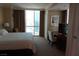 Bedroom with large window, desk area and comfortable bed at 145 E Harmon Ave # 27621, Las Vegas, NV 89109