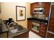 Kitchenette featuring stainless steel appliances and a sleek sink with stainless steel faucet at 145 E Harmon Ave # 27621, Las Vegas, NV 89109