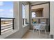 Balcony with a table and chairs, offering a cozy spot to enjoy the beautiful outdoor views at 1474 Whistling Kite St, Las Vegas, NV 89138