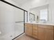 A modern bathroom features a sleek glass-enclosed shower and a double sink vanity at 1474 Whistling Kite St, Las Vegas, NV 89138