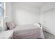 Bright bedroom features a neatly made bed and minimalist decor, enhanced by soft natural light from the window at 1474 Whistling Kite St, Las Vegas, NV 89138