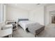 A well-lit bedroom featuring a bed, neutral colors, and large windows at 1474 Whistling Kite St, Las Vegas, NV 89138