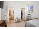 Bright bedroom featuring light wood floors, neutral walls, and an ensuite bathroom view at 1474 Whistling Kite St, Las Vegas, NV 89138