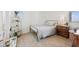 Cozy bedroom with wood floors, a metal bed frame, and natural light at 1474 Whistling Kite St, Las Vegas, NV 89138