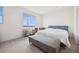 Light-filled bedroom featuring a comfortable bed with a gray bench and neutral decor at 1474 Whistling Kite St, Las Vegas, NV 89138