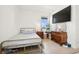 Comfortable bedroom with light wood floors, a decorative bed, and ample dresser space at 1474 Whistling Kite St, Las Vegas, NV 89138