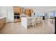Contemporary kitchen featuring stainless steel appliances, a large island, and seamless flow to living area at 1474 Whistling Kite St, Las Vegas, NV 89138
