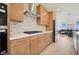 Gourmet kitchen featuring sleek cabinetry, modern appliances, and an open layout with a view of the living area at 1474 Whistling Kite St, Las Vegas, NV 89138