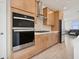 This modern kitchen features built-in stainless steel appliances, sleek light wood cabinetry, and stylish backsplash at 1474 Whistling Kite St, Las Vegas, NV 89138