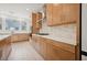 This kitchen features stainless steel appliances, light wood cabinets, stylish tile backsplash, and an efficient layout at 1474 Whistling Kite St, Las Vegas, NV 89138
