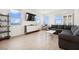 Spacious living room with large windows, modern decor, and wood flooring with ample natural light at 1474 Whistling Kite St, Las Vegas, NV 89138