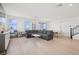 Bright and open living room with modern furnishings, wood floors, and natural light with space for dining at 1474 Whistling Kite St, Las Vegas, NV 89138