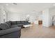 Expansive open-concept living area featuring a sectional sofa, modern finishes, and hardwood flooring at 1474 Whistling Kite St, Las Vegas, NV 89138