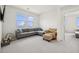 Bright living room features a comfortable sectional sofa and a large window view at 1474 Whistling Kite St, Las Vegas, NV 89138