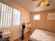 Well-lit bedroom with wood floors, ceiling fan and bright windows at 1515 Fort Dix Cir, North Las Vegas, NV 89031