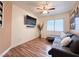 Cozy bedroom with a neutral color palette, hardwood floors, and a mounted television at 1515 Fort Dix Cir, North Las Vegas, NV 89031