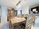 Elegant dining room featuring a large wooden table with ornate details and decorative light fixtures at 1515 Fort Dix Cir, North Las Vegas, NV 89031