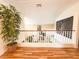 Bright hallway with wood floors, decorative plant, and view of the living area at 1515 Fort Dix Cir, North Las Vegas, NV 89031