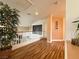 Upstairs hallway with wood floors, a small reading area, and natural light at 1515 Fort Dix Cir, North Las Vegas, NV 89031