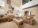 Bright living room with high ceilings, large windows, and comfortable leather sofas at 1515 Fort Dix Cir, North Las Vegas, NV 89031