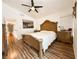 Spacious main bedroom with wood floors, a unique bedframe, and a large window allowing natural light at 1515 Fort Dix Cir, North Las Vegas, NV 89031