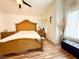Bright main bedroom features an ornate wood bedframe, wood floors and natural light from the window at 1515 Fort Dix Cir, North Las Vegas, NV 89031