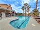 Enjoy the backyard pool featuring a sun-drenched patio surrounded by tropical palm trees and mature landscape at 1515 Fort Dix Cir, North Las Vegas, NV 89031