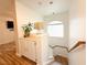 Bright stairway featuring white walls, built-in storage, and wood floors at 1515 Fort Dix Cir, North Las Vegas, NV 89031