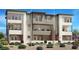 Modern three-story townhome featuring a sleek design and well-maintained landscaping at 1537 Stone Perch St, Las Vegas, NV 89138