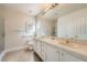 Bright bathroom featuring a double vanity, tile counters, and a shower at 1609 Hidden Spring Dr, Las Vegas, NV 89117