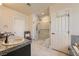 Modern bathroom features marble shower, granite counters, and white cabinets at 1609 Hidden Spring Dr, Las Vegas, NV 89117