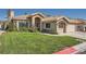 Charming single-story home showcasing a well-maintained lawn, tiled roof, and inviting front entrance at 1609 Hidden Spring Dr, Las Vegas, NV 89117