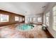 Indoor pool featuring tile flooring, large windows, and stone benches at 1609 Hidden Spring Dr, Las Vegas, NV 89117