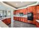 This spacious kitchen features extensive dark wood cabinetry, modern appliances, and ample counter space at 1609 Hidden Spring Dr, Las Vegas, NV 89117