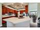 This modern kitchen boasts cherry cabinets, stainless steel appliances, and a sleek white countertop island at 1609 Hidden Spring Dr, Las Vegas, NV 89117