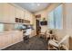 Well-lit office with custom built-in cabinetry, a workstation, and comfortable seating for guests at 1609 Hidden Spring Dr, Las Vegas, NV 89117