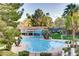 Beautiful swimming pool with sun loungers surrounded by mature landscaping at 1609 Hidden Spring Dr, Las Vegas, NV 89117