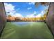 Community tennis court with green and blue surface, nets, and perimeter fencing at 1609 Hidden Spring Dr, Las Vegas, NV 89117