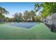 Community tennis court with green and blue surface, nets, and perimeter fencing at 1609 Hidden Spring Dr, Las Vegas, NV 89117