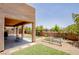 A backyard boasts a covered patio, well-kept lawn, garden beds, and brick-paved area offering versatile outdoor living space at 1699 Sonoran Bluff Ave, Henderson, NV 89014