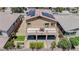Well-maintained backyard featuring a balcony, patio, manicured lawn, garden beds, and neutral-toned stucco at 1699 Sonoran Bluff Ave, Henderson, NV 89014