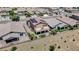 Aerial view of backyard featuring a balcony, patio, manicured lawn, garden beds, and privacy wall at 1699 Sonoran Bluff Ave, Henderson, NV 89014