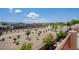 A serene balcony offers a view of the walking paths surrounded by mature landscaping and beautiful desert homes at 1699 Sonoran Bluff Ave, Henderson, NV 89014