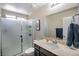 Bathroom with walk-in shower, single vanity, and a large mirror at 1699 Sonoran Bluff Ave, Henderson, NV 89014