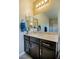 Bright bathroom featuring single vanity, a large mirror, countertop space, and soft lighting at 1699 Sonoran Bluff Ave, Henderson, NV 89014