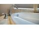 Close-up of a sleek faucet and a modern bathtub, showcasing contemporary bathroom features at 1699 Sonoran Bluff Ave, Henderson, NV 89014
