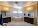 Spacious bathroom featuring dual vanities, a soaking tub, and neutral tile flooring at 1699 Sonoran Bluff Ave, Henderson, NV 89014