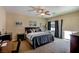 Spacious bedroom featuring a ceiling fan, neutral carpet, ample space, and natural light at 1699 Sonoran Bluff Ave, Henderson, NV 89014