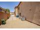 The home features a gravel side yard with air conditioning units and a brick driveway with access to a detached garage at 1699 Sonoran Bluff Ave, Henderson, NV 89014